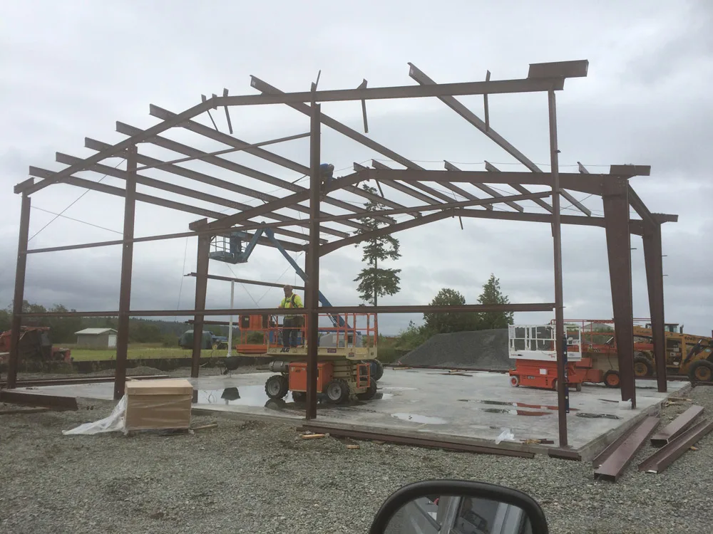 Steel structure framing with crew working on lifts